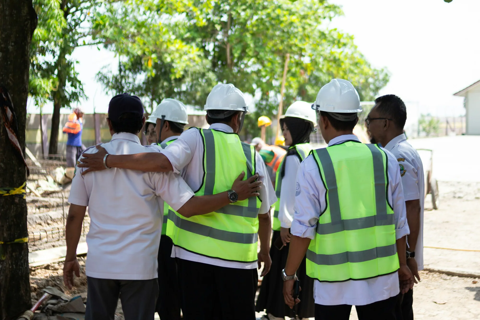 Construction crew members conferring on a job site