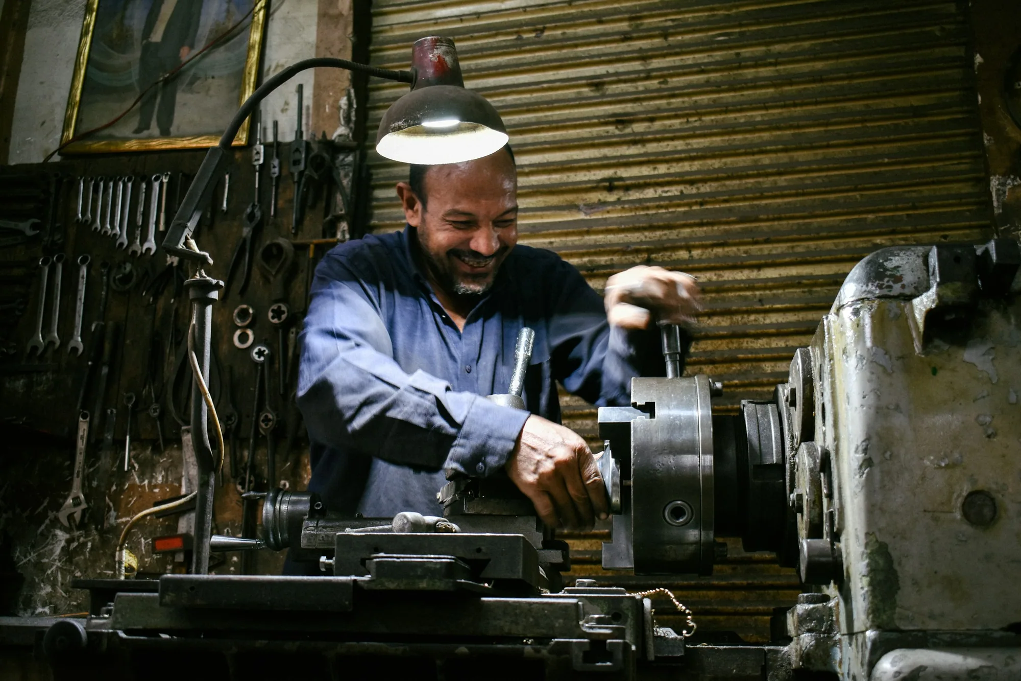 A business owner working in a machine shop