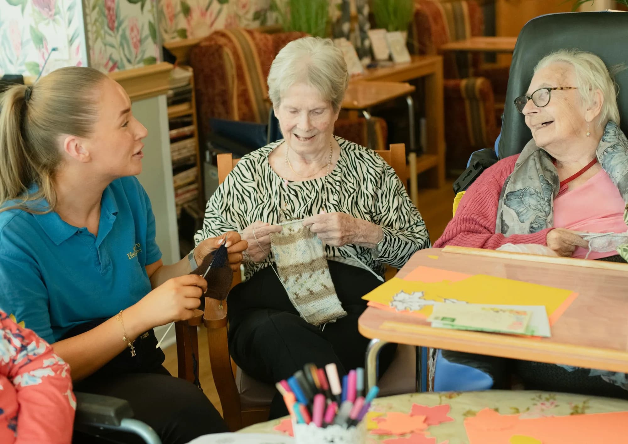 A caregiver supporting older adults during a shared activity